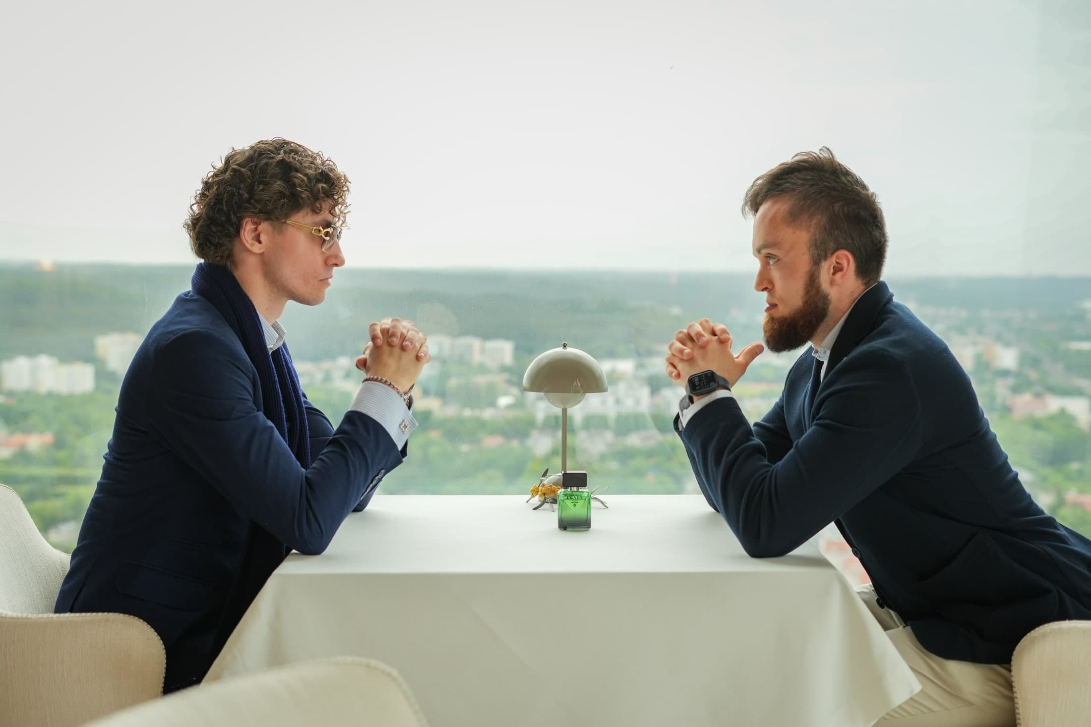 Simon and Patryk facing each other across a table at ARCO by Paco Pérez, above Gdańsk